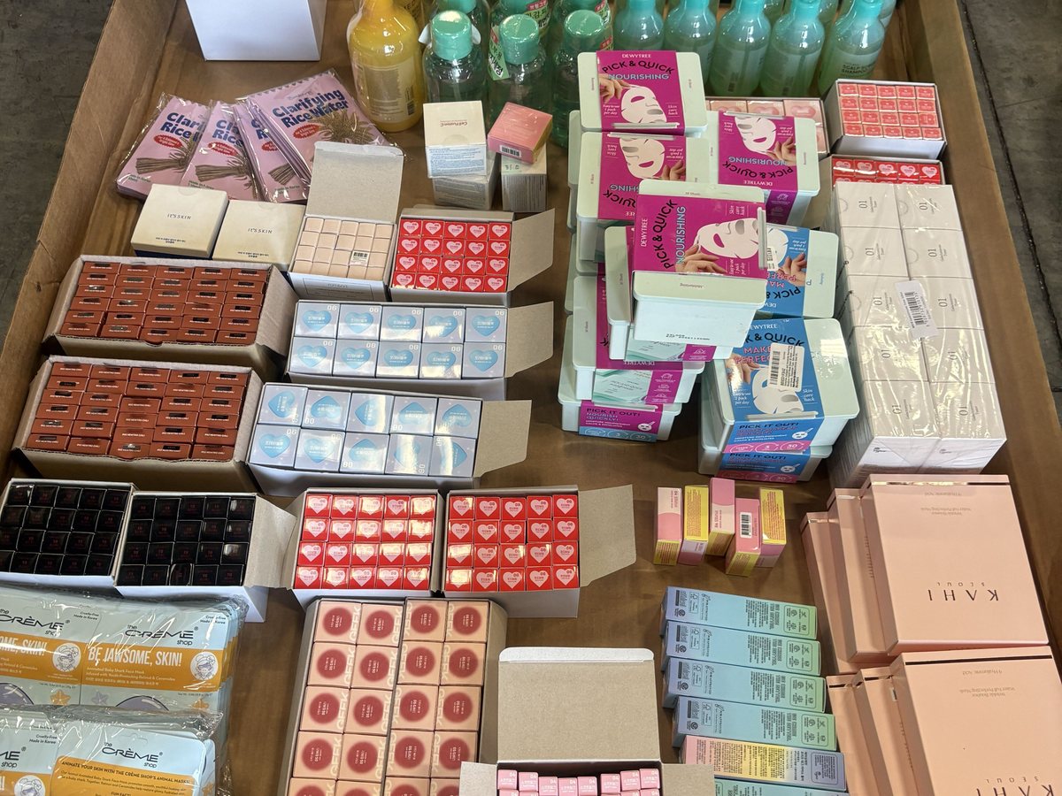 Case packs of assorted Korean beauty products in a warehouse carton
