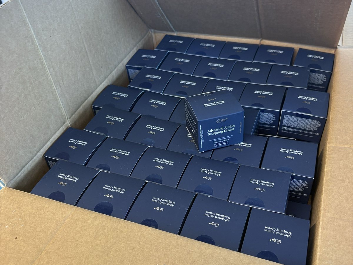 Navy boxed skincare units packed in a carton