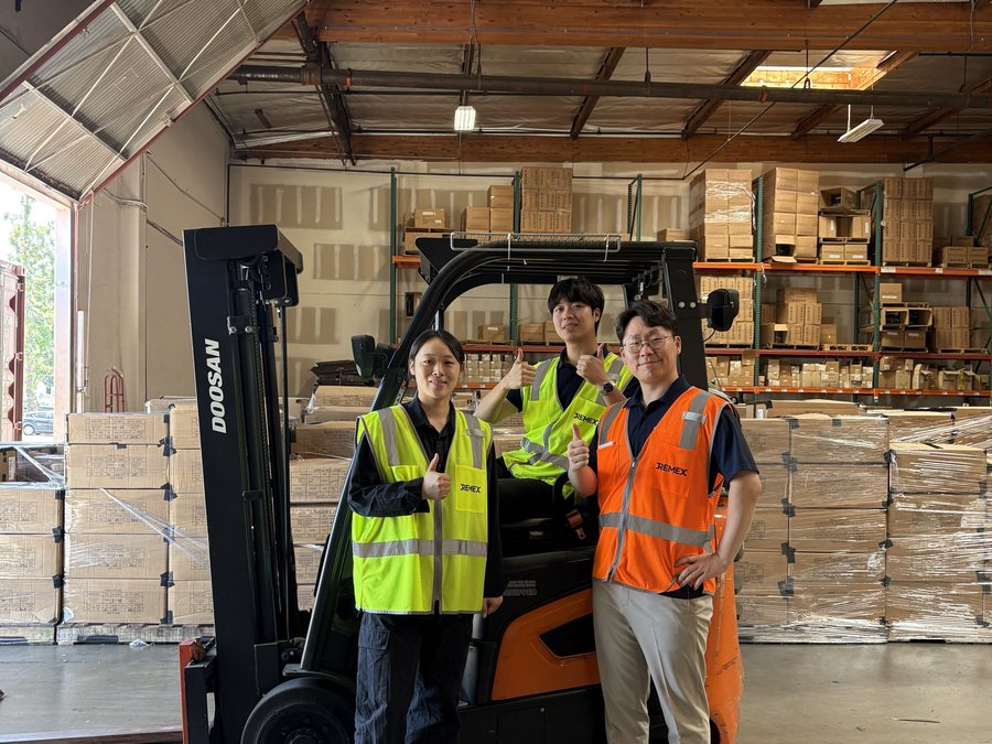 Warehouse staff loading pallets with a forklift